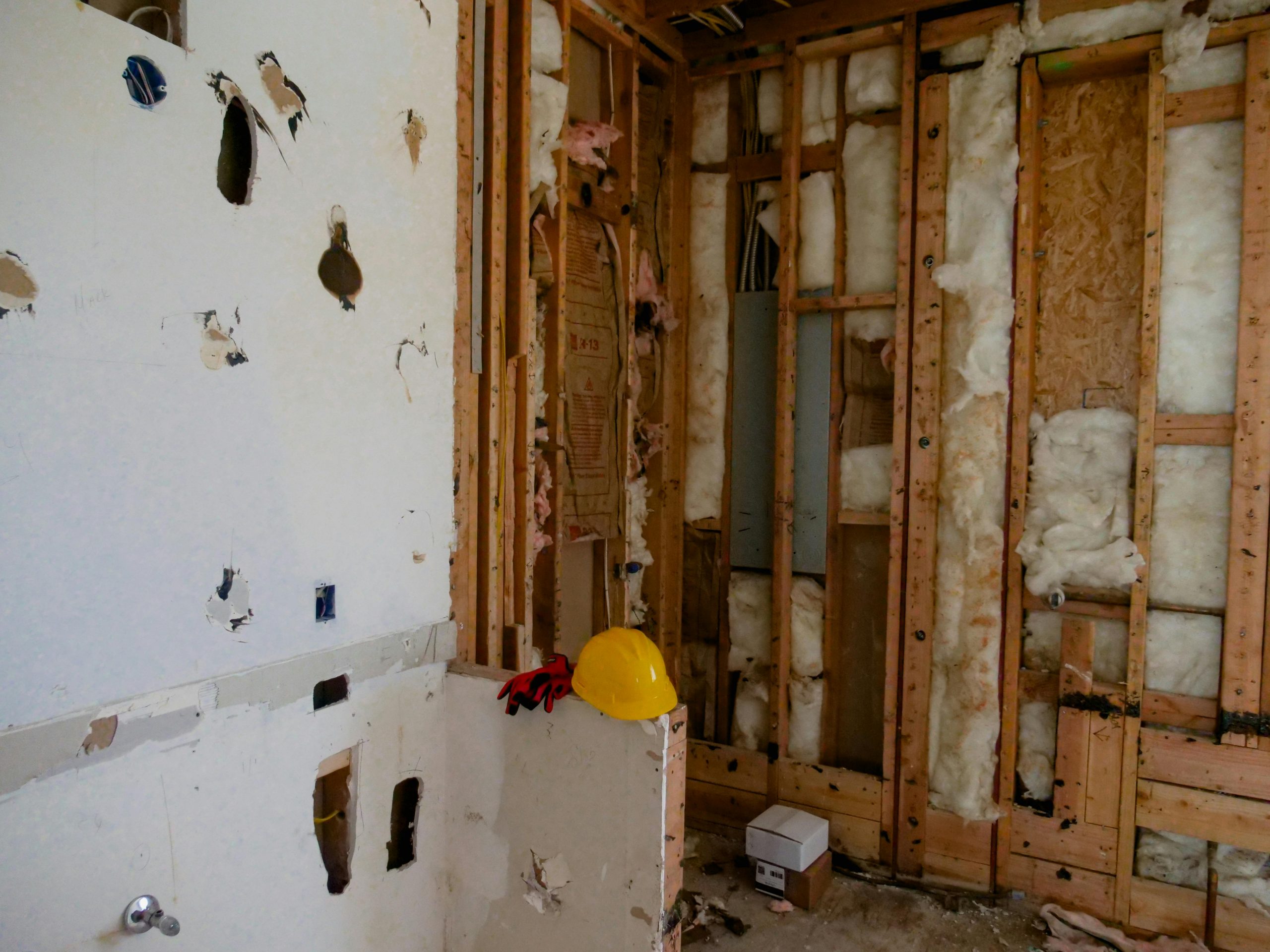 room under renovation with exposed soundproof insulation in the walls