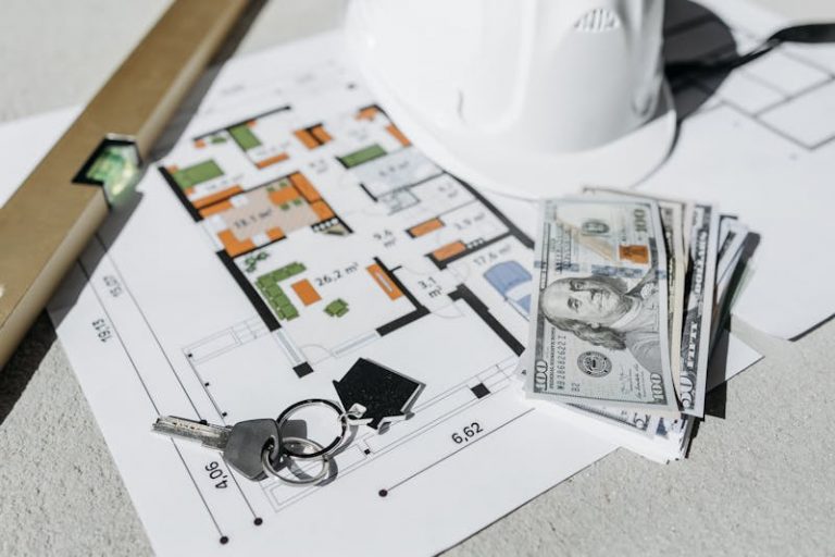 a home plan, house keys, a leveling tool, and some cash